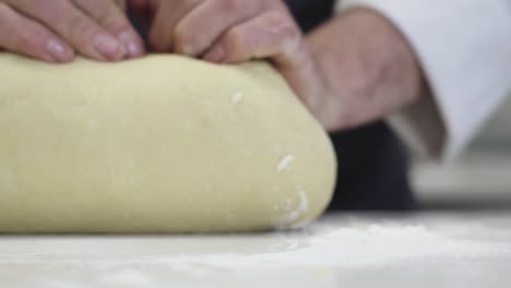 Cinematic-close-up-of-a-baker-kneading-fresh-dough