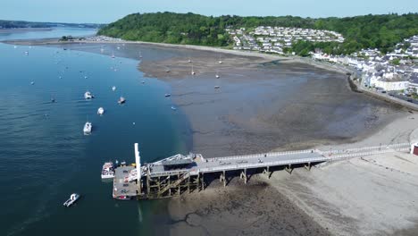 Sunny-Beaumaris-pier-aerial-view-relaxing-seaside-waterfront-tourist-attraction-Welsh-landmark-high-orbit-left