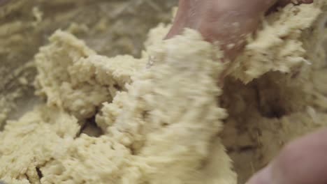 Extreme-close-up-of-a-baker's-hands-mixing-dough