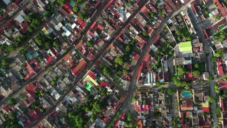 Top-Down-Aerial-View-of-Honda-Town,-Tolima,-Colombia,-Colorful-City-Buildings-on-Golden-Hour-Sunlight,-High-Angle-Drone-Shot