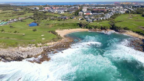 Little-Bay-Beach-With-Rock-Ledges-And-The-Eastern-Suburbs-In-South-Eastern-Sydney,-Australia