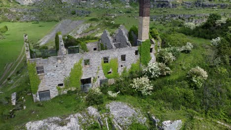 Abandoned-overgrown-ivy-covered-desolate-countryside-historical-Welsh-coastal-brick-factory-mill-aerial-view-descending-close-up