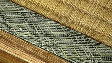 Edge-of-tatami-mat-covered-in-fabric-with-woven-pattern