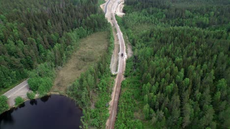 Flying-Over-Railway-Construction-Site-Next-to-Lake,-Sweden,-Aerial