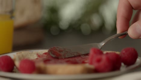 Spreading-delicious-flavor-vegan-jam-during-breakfast-meal-zoom-in-close-up-shot