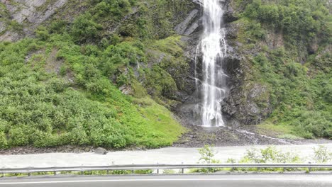 waterfall-on-side-of-road-aerial