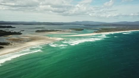 Sideways-drone-footage-off-the-coast-of-the-mouth-of-the-Wallagaraugh-River-at-Mallacoota-at-low-tide,-eastern-Victoria,-Australia,-December-2020