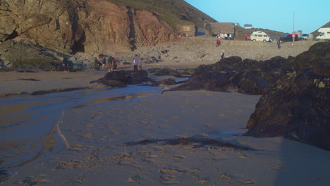 Vacationists-On-Chapel-Porth-Beach-With-Car-Park-In-Cornwall,-UK