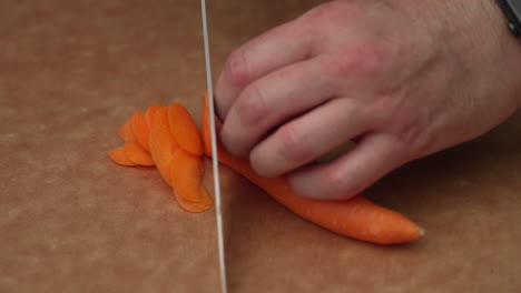 Thinly-Sliced-Carrots-On-A-Wooden-Board