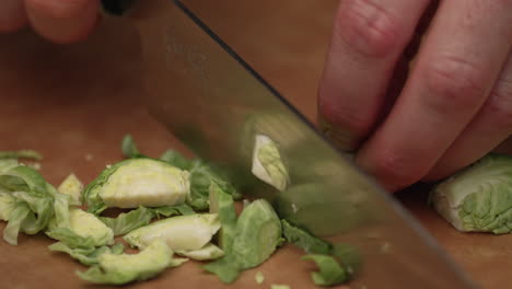 Person-Slicing-Fresh-Brussels-Sprout-Using-Kitchen-Knife