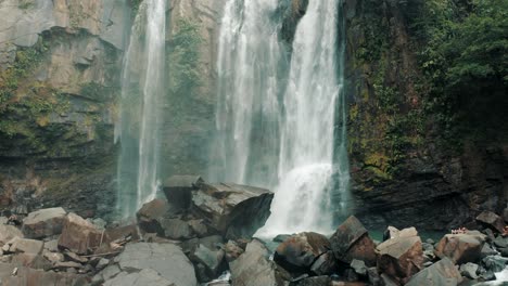 People-relaxing-on-rocks-at-Nauyaca-Waterfalls-in-Costa-Rica