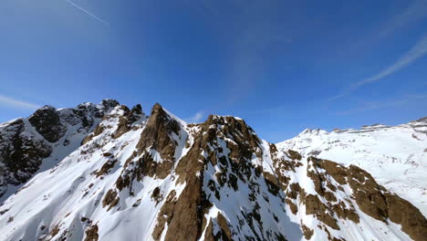 Snowcapped-Mountain-Ridge-And-Ski-Slopes-At-Les-Marecottes-Ski-Resort,-Valais,-Switzerland-With-Dents-du-Midi-Mountains-And-Frozen-Salanfe-Lake-On-the-Backdrop