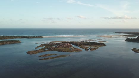 Sideways-aerial-footage-of-the-mouth-of-the-Wallagaraugh-River-at-Mallacoota,-eastern-Victoria,-Australia,-December-2020