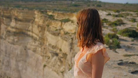 Young-Caucasian-Girl-Looking-Enjoying-View-at-Ta'-Ċenċ-Cliffs,-Gozo,-Malta