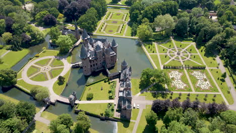 Stunning-aerial-of-beautiful-fairy-tale-castle-surrounded-by-a-green-garden
