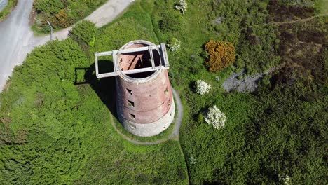 Amlwch-port-red-brick-disused-abandoned-windmill-aerial-view-North-Anglesey-Wales-birdseye-right-orbit