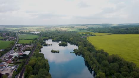 Aerial-footage-flying-over-a-lake-on-Chilham,-Kent,-UK