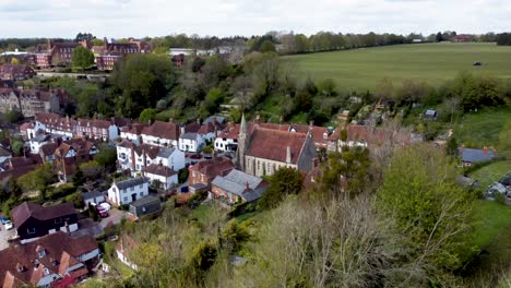 A-drone-real-shot-of-a-church-in-a-small-village-in-Kent,-England