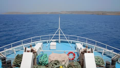 A-large-ferry-in-the-ocean-going-from-Malta-Island-to-Gozo,-static-shot-from-the-front-deck