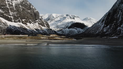 Ersfjord-Beach-With-Snow-Covered-Mountains-On-Background-In-Senja-Island,-Norway---aerial-pullback