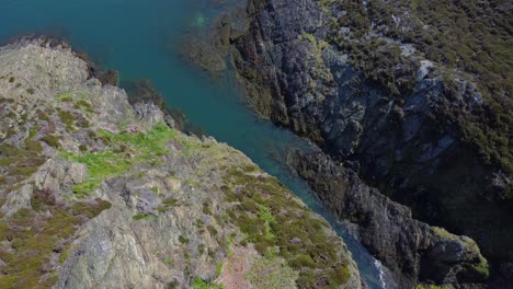 Peaceful-Amlwch-Anglesey-North-Wales-rugged-mountain-coastal-walk-aerial-view-birdseye-tilt-up-reveal