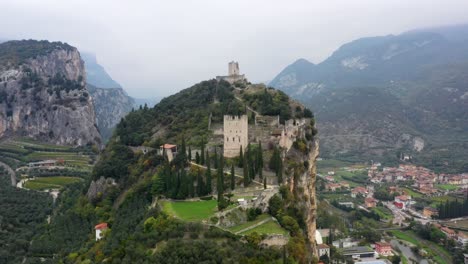 Aerial-footage-of-city-of-Arco-and-Arco-Castle,-Lake-Garda,-Lago-di-Garda,-Trentino,-Italy,-Europe