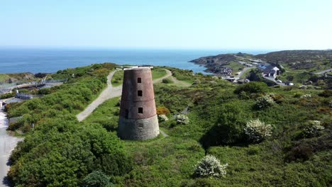 Amlwch-port-red-brick-disused-abandoned-wooden-windmill-aerial-view-North-Anglesey-Wales-slow-rising-right