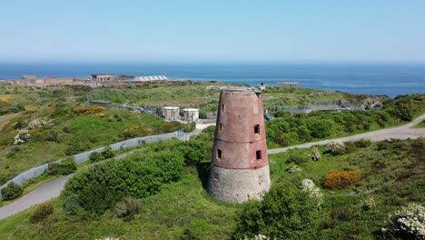 Amlwch-port-red-brick-disused-derelict-windmill-aerial-view-North-Anglesey-Wales-orbit-right