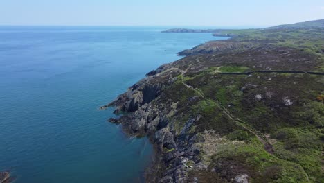 Peaceful-Amlwch-Anglesey-North-Wales-rugged-mountain-coastal-walk-aerial-view-dolly-right