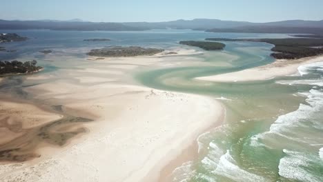 Aerial-footage-flying-towards-the-mouth-of-the-Wallagaraugh-River-at-Mallacoota-at-low-tide,-eastern-Victoria,-Australia,-December-2020