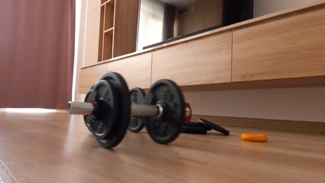 Dumbbells-roll-on-the-floor-in-the-living-room