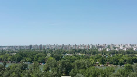 Aerial:-Belgrade-city-skyline-on-summer-day,-view-over-Ada-Ciganlija-in-Serbia