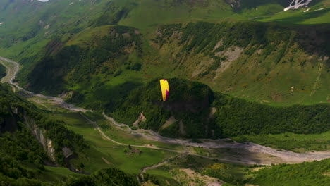 Chasing-drone-shot-of-people-paragliding-in-the-Caucasus-mountains-in-Gudauri-Georgia