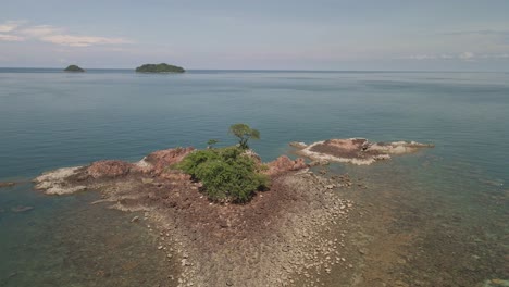 4K-Aerial-Rotating-Around-Small-Rocky-Island-with-Isolated-Tree-in-Thailand