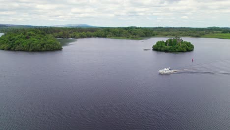 Aerial-view-of-a-yacht-on-Lough-Key-with-McDermott's-castle-in-the-background