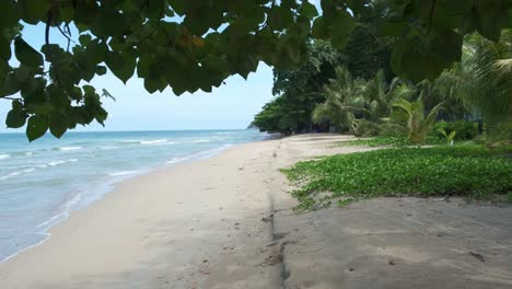 4K-Beautiful-Scenic-Beach-View-with-Palm-Trees-and-Vegetation-on-a-Summers-Vacation-in-Koh-Chang,-Thailand
