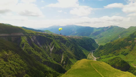 Cinematic-drone-shot-of-a-paraglider-flying-in-the-mountains-in-Gudauri-Georgia