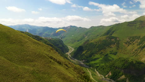 Cinematic-chasing-drone-shot-of-paraglider-in-the-mountains-of-Gudauri-Georgia