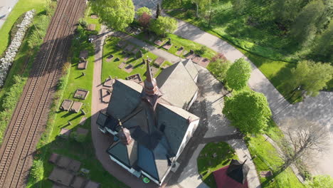 Aerial-Drone-Footage-of-Church-and-Graveyard-in-Lerum,-Town-in-Vastra-Gotaland,-Sweden