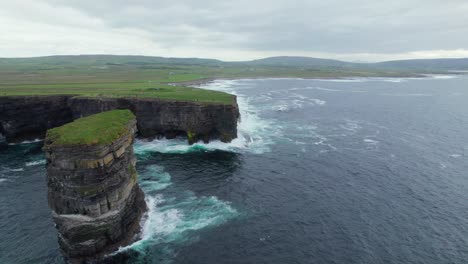Aerial-view-of-Downpatrick-rock-and-cliffs-overseeing-green-fields