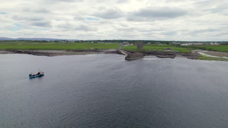 Aerial-view-of-O'Dawd-castle-with-approaching-boat-towards-the-coast