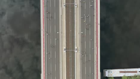 Drone-overhead-view-of-runners-crossing-a-bridge-in-a-marathon