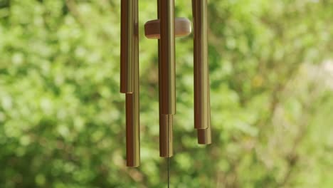 Metal-wind-chime-natural-green-background-slow-motion-120p