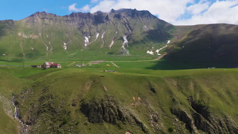 Wide-drone-shot-of-paraglider-in-the-mountains-of-Gudauri-Georgia