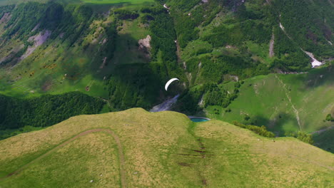 Downward-angle-drone-shot-tracking-a-paraglider-in-Gudauri-Georgia