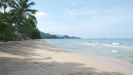 4K-Scenic-View-of-Tropical-Beach-with-Ocean-Waves-and-White-Sand-in-Koh-Chang,-Thailand