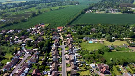 High-altitude-view-of-a-road-running-through-the-village-of-Littlebourne-in-Kent,-UK