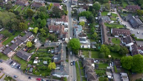 Aerial-video-following-a-road-through-a-village-in-Kent,-UK