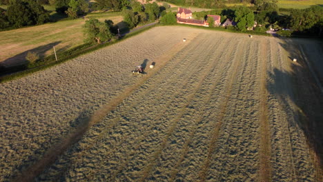 Long-evening-shadows-are-cast-over-the-land-as-a-tractor-works-in-a-field-in-the-Worcestershire
countryside-in-England