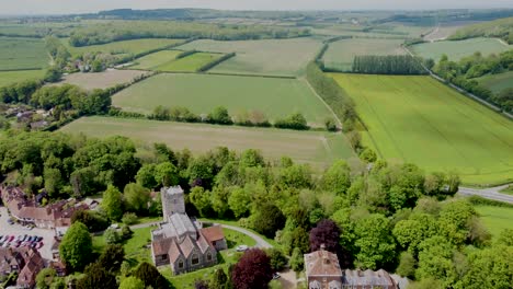 Flying-towards-the-village-church-in-Chilham,-Kent